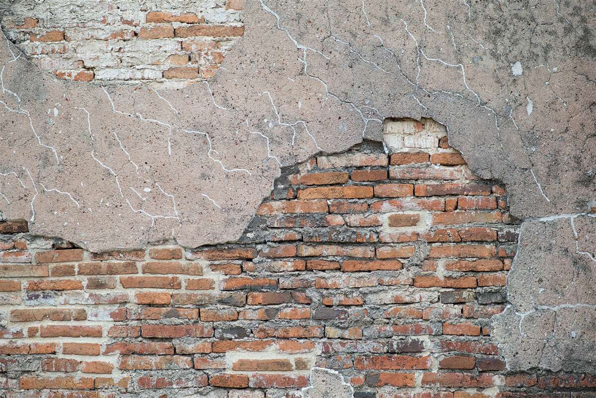 Fototapet Un zid de cărămidă care se prăbușește